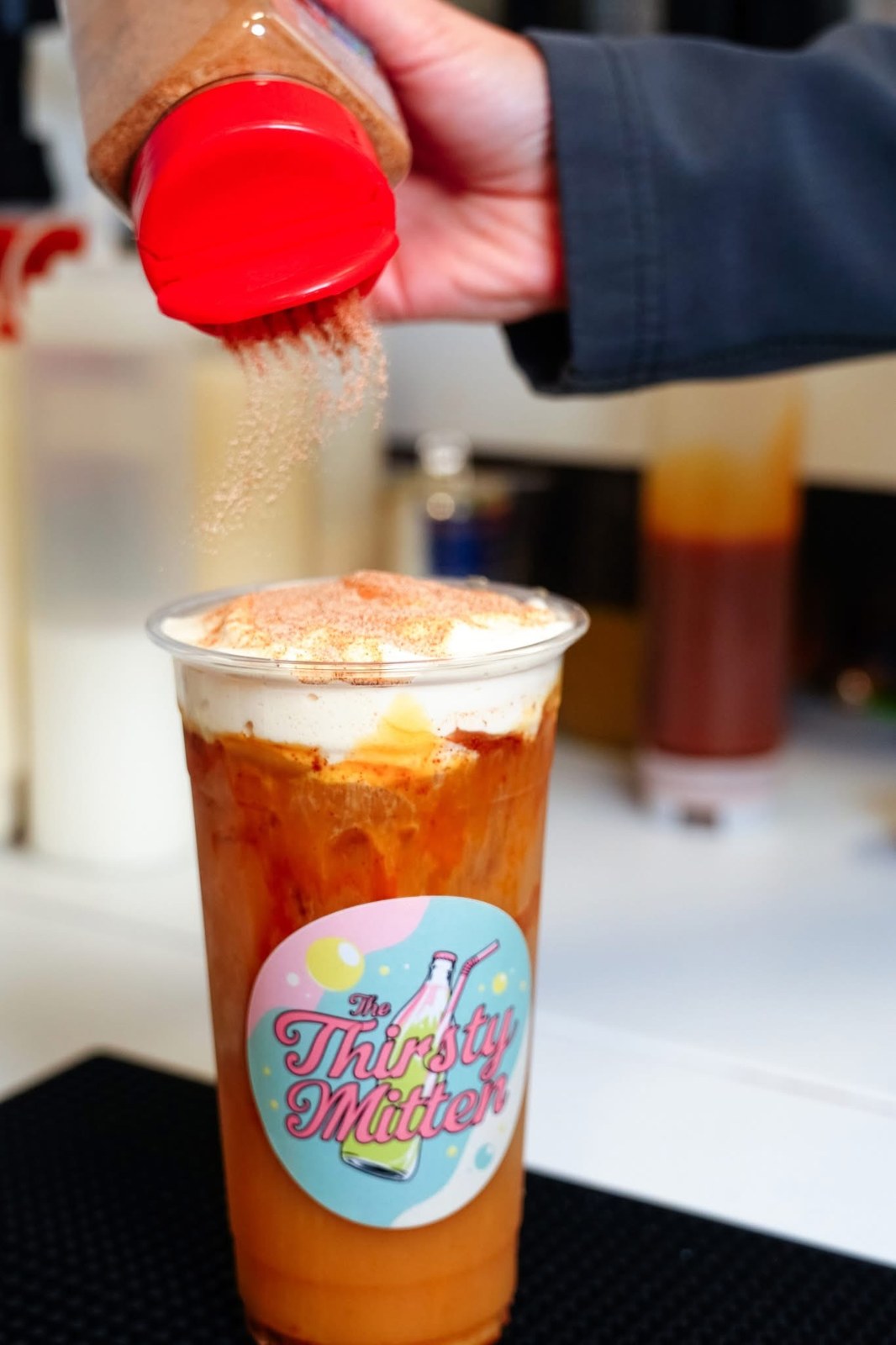 Cold foam being added to a Thirsty Mitten specialty drink