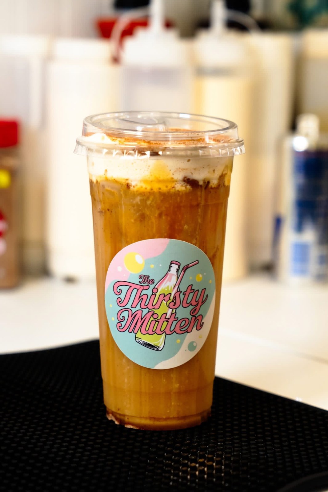 A freshly made Thirsty Mitten drink in a branded clear cup